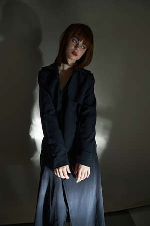 Dark background funny person black cloak photo studio