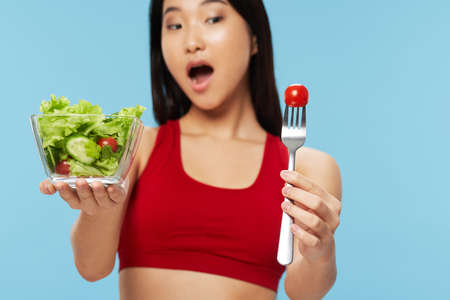 Plate with salad healthy food lifestyle diet woman with a slender figureの写真素材