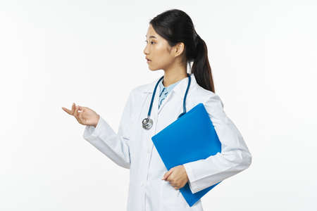 Woman doctor in a medical gown documents health laboratory stethoscopeの写真素材