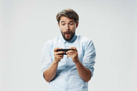 A bearded man holds a smartphone in his hands internet smart appliances