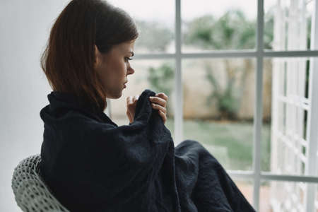 upset woman with a plaid on her shoulders
