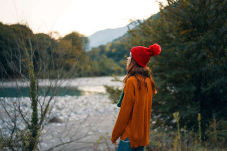 traveler in the woods near the river in the mountainsの写真素材