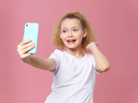 Child with a mobile phone beautiful girl on a background