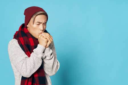 Man warms his hands cold checkered scarf coldの写真素材