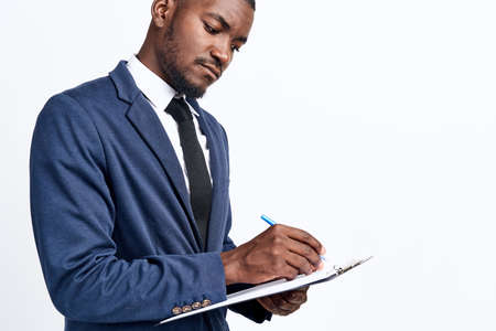 portrait of a handsome man of African appearance in a suit on a light background cropped view close-up modelの写真素材