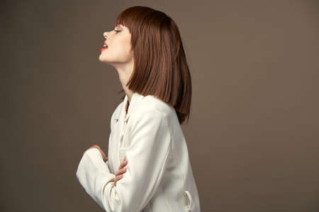 model in light coat pose for the camera photo studio
