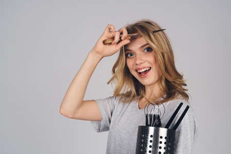 woman with kitchen appliances on gray background emotions model housewifeの写真素材