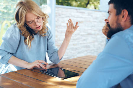 Man and woman outdoors work colleagues communicating phone teamwork