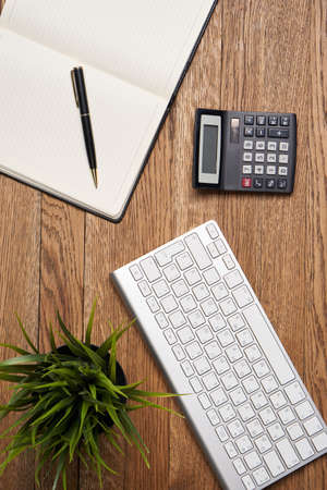 Notepad with pen stationery accessories beige backgroundの写真素材