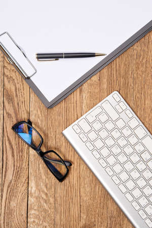Notepad with pen stationery accessories beige backgroundの写真素材