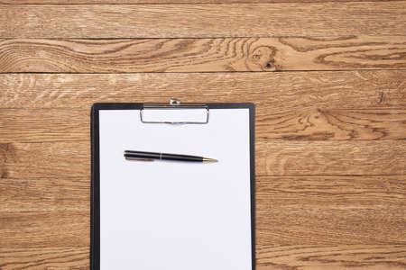 Notepad with pen stationery accessories beige backgroundの写真素材