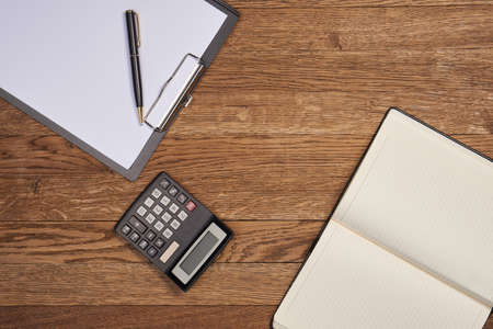 Notepad with pen stationery accessories beige backgroundの写真素材