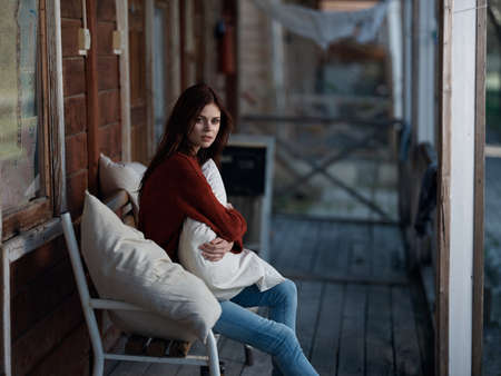 woman sitting on bench on terrace at home leisure fresh air lifestyleの写真素材