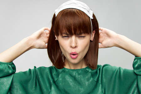 Woman in fashion dress posing in medical mask virus covid-19の写真素材