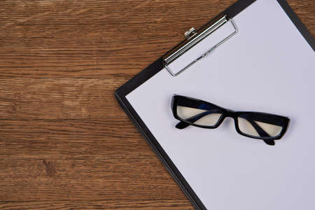 Notepad with pen stationery accessories beige backgroundの写真素材