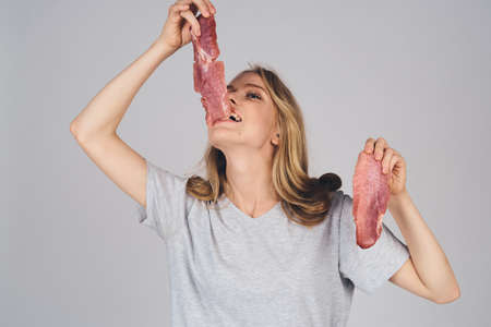 emotional woman with groceries in hands on gray background food model cropped viewの写真素材