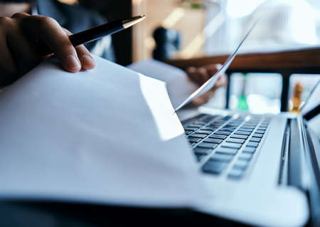 business man in suit in front of laptop with book work communication technologyの写真素材