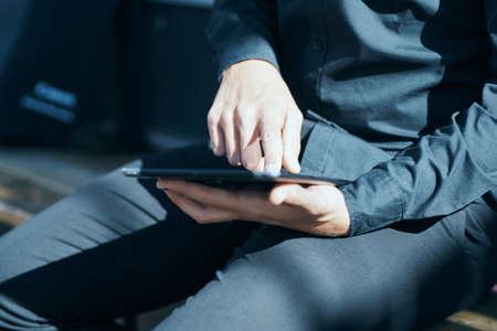 Manager with a tablet in hands outdoors technology communicationの写真素材