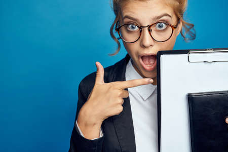 Woman businesswoman with documents on blue background gesturing with hands Copy Space