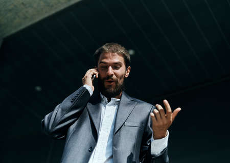 business man in a suit talking on the phone outdoors business manager executiveの写真素材