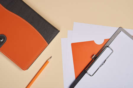 Notepad with pen stationery accessories beige backgroundの写真素材