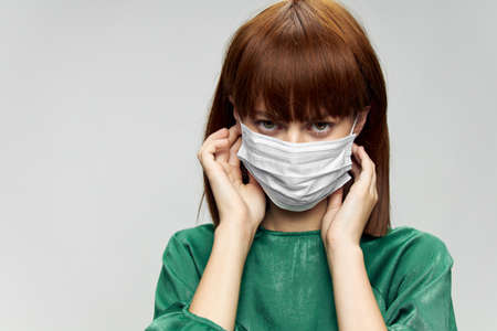 Woman in fashion dress posing in medical mask virus covid-19の写真素材