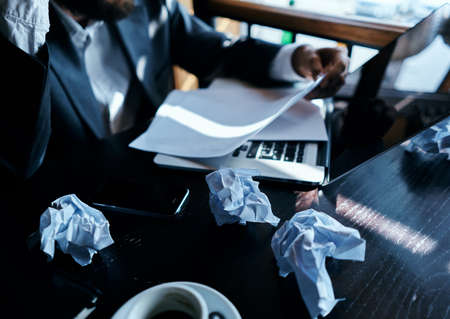 Business man in a cafe sitting at the table documents laptop crumpled paper executive lifestyle...