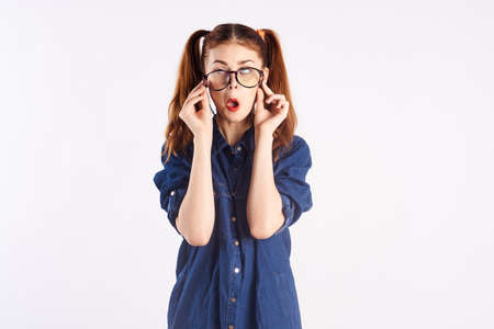 girl in a blue shirt bright makeup glasses student emotions model fun