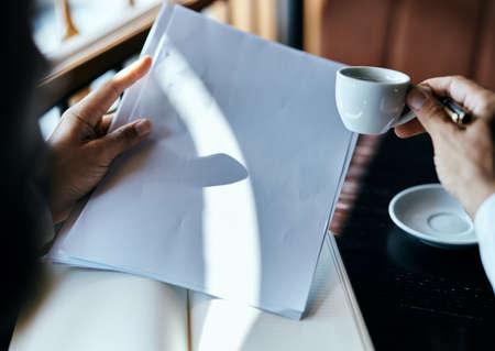 businesswoman in a cafe with a book on the table documents a cup of coffee work lifestyleの写真素材