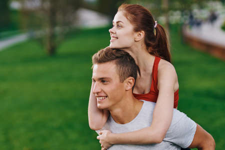 woman on back men outdoors walk fun lifestyleの写真素材