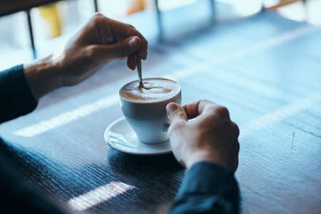 cafe restaurant table male hands coffee cup modelの写真素材