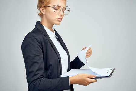 Woman in a suit of an official businesswoman documents in a work folder
