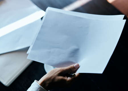 businesswoman in a cafe with a book on the table documents a cup of coffee work lifestyle