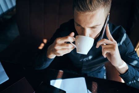Business man freelancer working in a cafe laptops communication phone room manager modelの写真素材