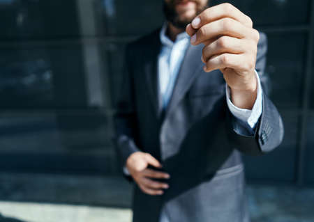 A business man outdoors holds the hand of an official close-up