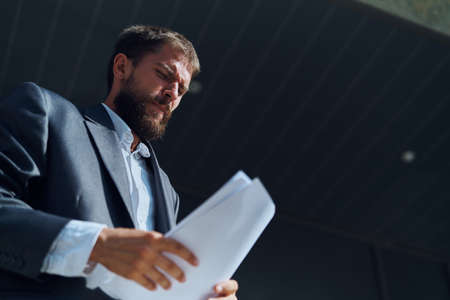 Business man outdoors with documents in hands near building official lifestyle
