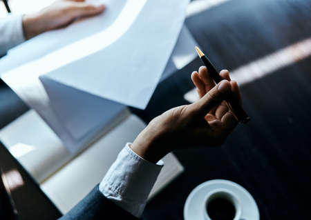 A business man in a suit is sitting in a cafe or with a laptop the work is an officialの写真素材