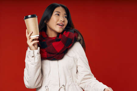 woman with a cup of drink winter clothes cool lifestyle