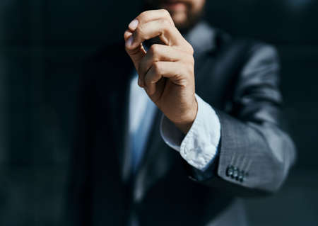 A business man outdoors holds the hand of an official close-up