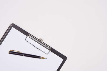 Notepad with pen stationery accessories beige backgroundの写真素材