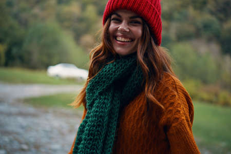 Woman Tourist green scarf sweater Red hat travel autumn fresh air