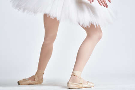 Ballerina in a white tutu dance performed on a light backgroundの写真素材