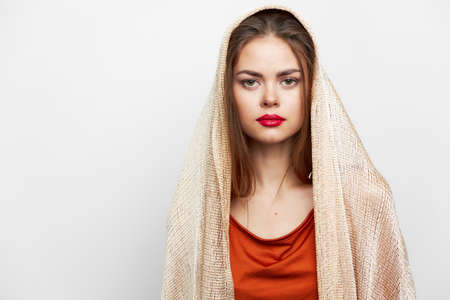 Woman with a scarf Glamor red lips look ahead model with cosmetics on the faceの写真素材
