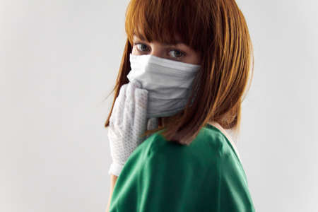 Woman in fashion dress posing in medical mask virus covid-19の写真素材