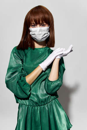 Fashion female coronavirus, model posing with gloves and protective medical maskの写真素材