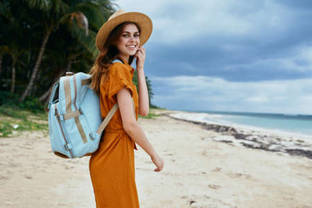 traveler with a backpack in nature turned to the cameraの写真素材