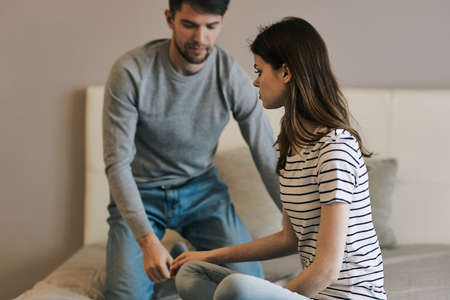 young loving couple of European appearance finds out the relationship on the bedの写真素材