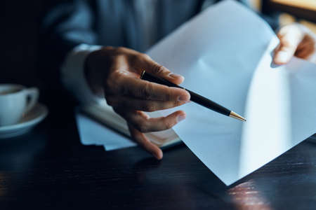 Work desk man holding documents office finance lifestyle officialの写真素材