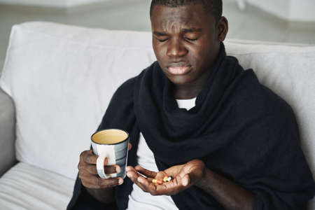 Man with medicines in his hands cold headache discontentの写真素材