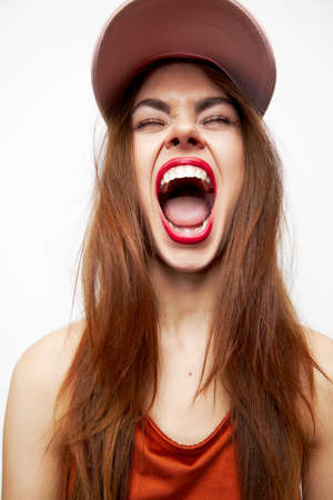 Emotional woman in a cap Wide open mouth closed eyes charm modelの写真素材
